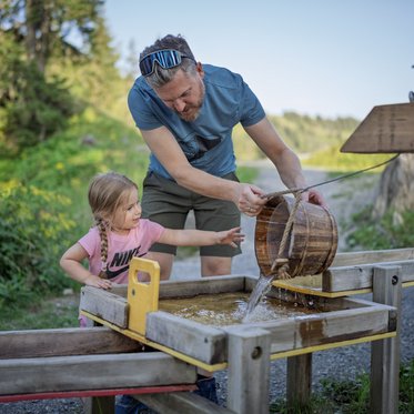 Familie am Wasserspielplatz am Fulseck in Dorfgastein